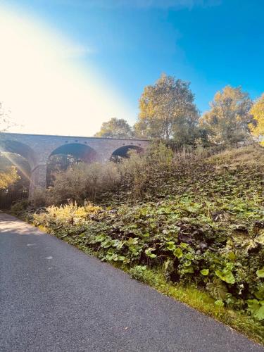 a road with a bridge in the background at East Learmouth Lakeside Lodges in Cornhill-on-tweed