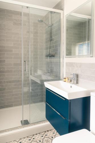 a bathroom with a sink and a shower at The Seaview, East Preston in Littlehampton