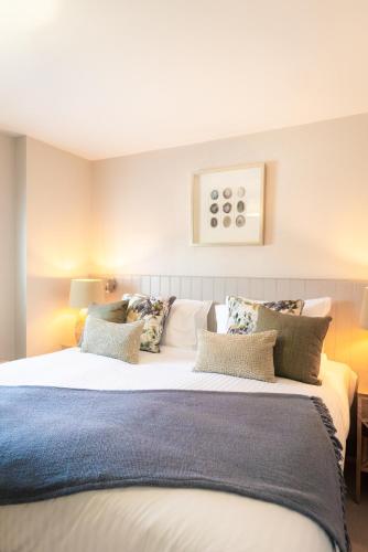 a bedroom with a large white bed with pillows at The Seaview, East Preston in Littlehampton