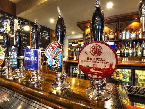 a bar with a bunch of bottles of alcohol at Masons Freehouse in Ingleton