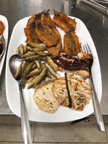 a plate of food with meat and french fries at mammaCristina in Patti