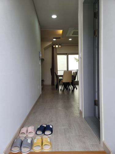 a hallway with several pairs of shoes on the floor at Secret Garden Pension in Yeosu