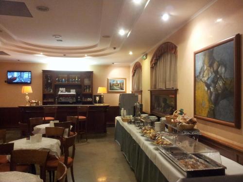 a restaurant with a buffet line with food on it at Hotel Traiano in Civitavecchia