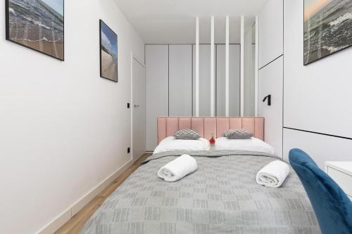 a bedroom with a large bed with two pillows at Pobierowo Plaża & SPA - Apartament na Wydmach by Noclegi Renters in Pobierowo