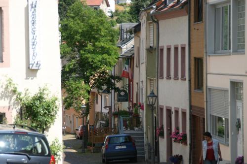 a woman walking down a street next to a building at Hotel zum alten Brauhaus in Dudeldorf