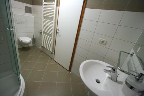 a bathroom with a sink and a toilet at Villa Segetski dvori - Tradition since 1964 in Trogir
