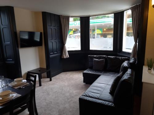 a living room with a couch and a table at Entire holiday home with FREE parking & fast WIFI in Ambleside