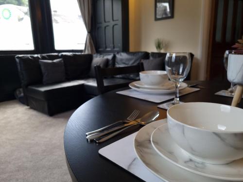 a dining room table with a bowl and a glass at Entire holiday home with FREE parking & fast WIFI in Ambleside