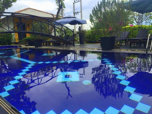 a pool of water with a person in the water at Flower Garden Lake Resort in Tissamaharama