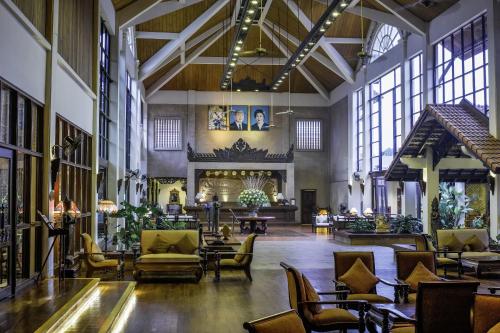 a large lobby with chairs and tables and windows at Palace Residence & Villa Siem Reap in Siem Reap