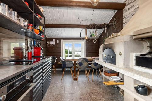 a kitchen with a table and a large oven at Libeli- panoramaview towards Gaustadtoppen- Jacuzzi in Lona