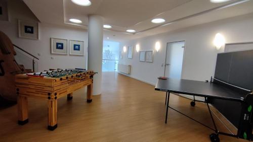 a room with a foosball table and a television at Pension Kricklsäge in Philippsreut