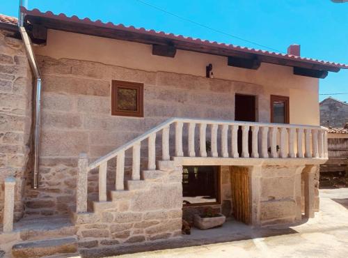 a stone house with a staircase in front of it at ACASADOCRUCEIRO 