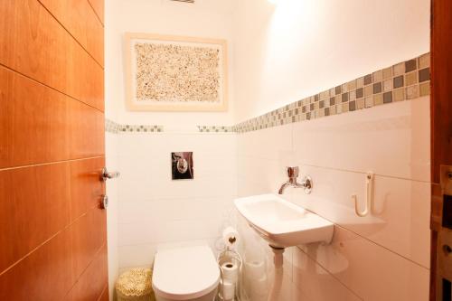 a bathroom with a sink and a toilet at Penthouse & Jacuzzi in Neve Tzedek by FeelHome in Tel Aviv