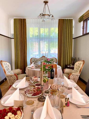 a dining room table with plates of food on it at Villa Meri in Pärnu
