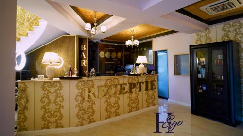 a bar in a hotel room with a reception counter at HEgo in Hunedoara