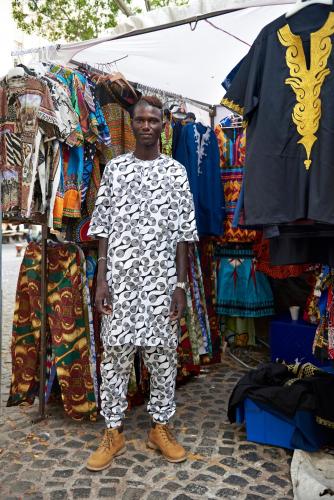 a man standing in front of a market stall at Gorgeous George by Design Hotels ™ in Cape Town
