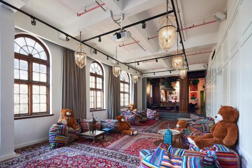 a room with several teddy bears sitting on couches at Gorgeous George by Design Hotels ™ in Cape Town