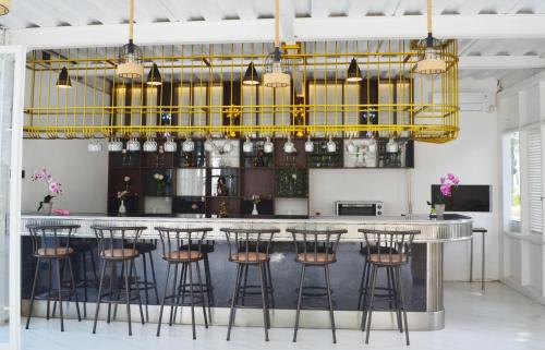 a bar with a bunch of stools in a room at Chevilly Resort & Camp in Bogor