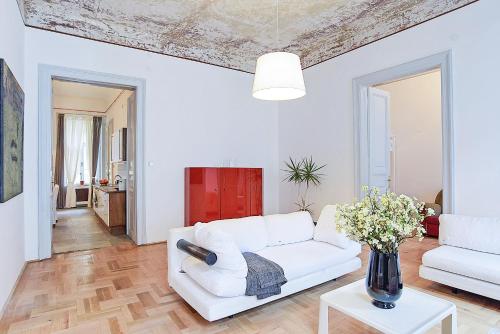 a living room with a white couch and a table at Beautiful apartment in 7th district in Budapest
