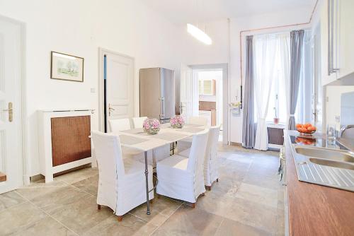 a kitchen and dining room with a table and chairs at Beautiful apartment in 7th district in Budapest
