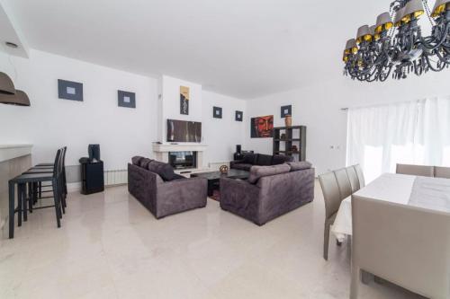 a living room with two couches and a dining table at Villa Eagle Eye Montenegro in Kotor