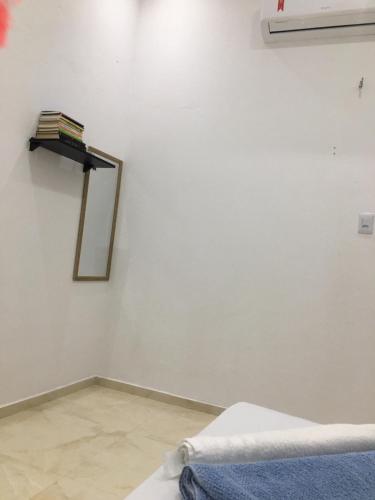 a room with a bed and a mirror on the wall at Rosana House Bem estar em Barreirinhas Ideal para 5 pessoas in Barreirinhas