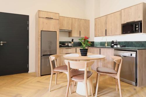 a kitchen with a table and chairs in a kitchen at Hyatt House Johannesburg Rosebank in Johannesburg