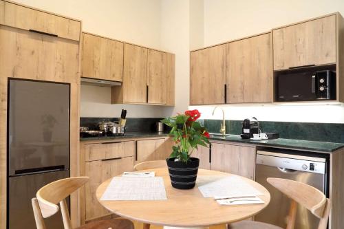 a kitchen with a table with a plant on it at Hyatt House Johannesburg Rosebank in Johannesburg