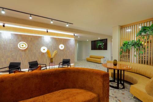 a living room with a couch and a table at Hyatt House Johannesburg Rosebank in Johannesburg