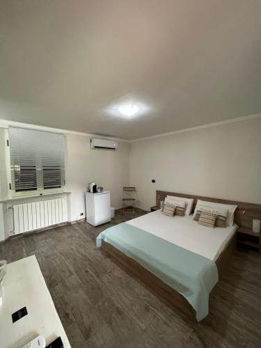 a bedroom with a large bed and a window at B&b Le Grotte in Portoferraio