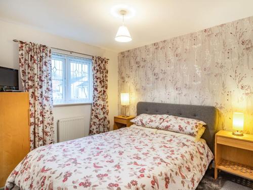 a bedroom with a bed and two night stands at Monument Way in Ulverston