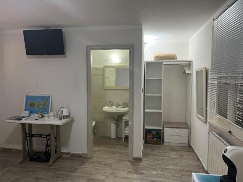 a bathroom with a sink and a toilet and a mirror at B&b Le Grotte in Portoferraio