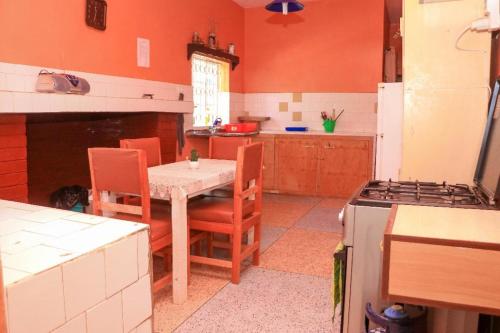 a kitchen with a table and chairs and a stove at Nyahururu Highlands Heaven -BnB in Nyahururu