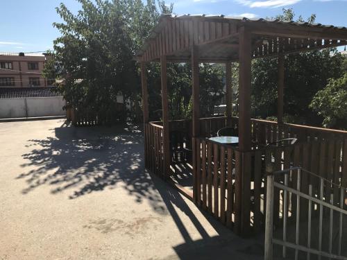 a playground with a wooden gazebo at Guest House Eden in Tbilisi City
