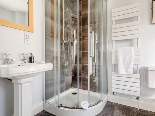 a bathroom with a shower and a sink at Claysun House in Whitecroft