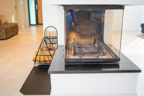 a fireplace in a living room with a stove at Villa 7 in Međugorje
