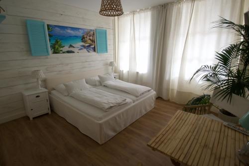 a bedroom with a bed and a potted plant at Landhaus Hamm in Düsseldorf