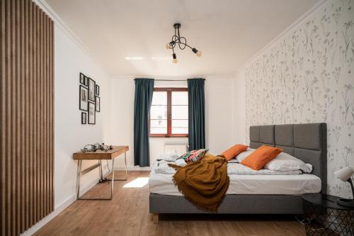 a bedroom with a bed and a desk in it at LeoApart in Wrocław