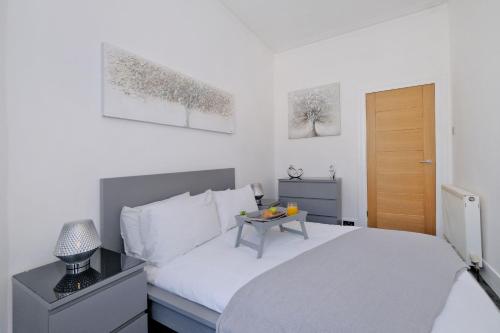 a bedroom with a bed with a table on it at Orange Apartments Union Grove in Aberdeen