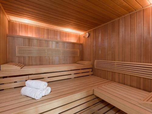 a wooden sauna with two towels sitting in it at Landhaus Margarethe in Hopfgarten im Brixental