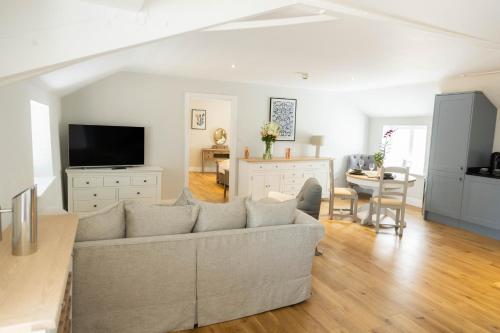 a living room with a couch and a table at The Unicorn (Apartments) in Stow on the Wold