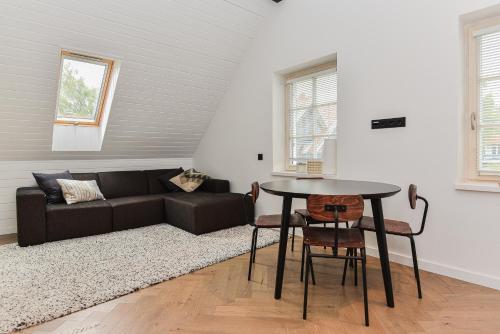 a living room with a couch and a table at Fisheria Apartamentai in Preila