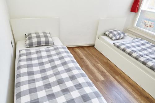 two beds in a room with two pillows at Lovecroatia Zagreb - 'Pax nest' in Zagreb