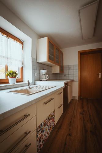 a kitchen with a sink and a counter top at FERIENPARADIES AM KAMMERBERG - ein ganzes Haus für Sie alleine!!! in Weißenhorn