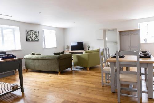 a living room with a couch and a table at The Unicorn (Apartments) in Stow on the Wold