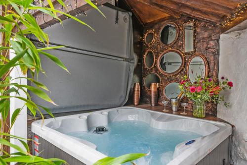 a bath tub with a sink in a room at Cramwell in Exeter