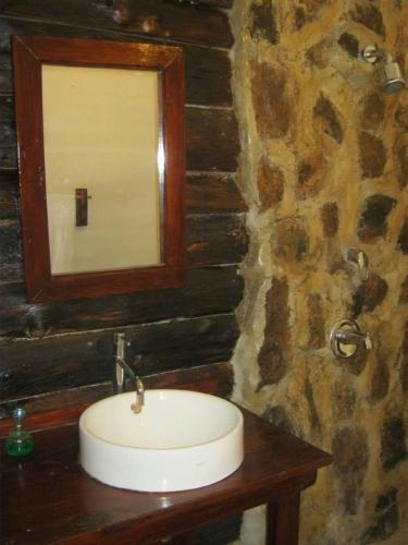 a bathroom with a sink and a mirror on a wall at Ngari Hill EcoLodge, Maralal - Kenya in Maralal