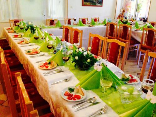 a long table with plates of food and flowers on it at Ski apartmány Spiežovec Donovaly in Donovaly