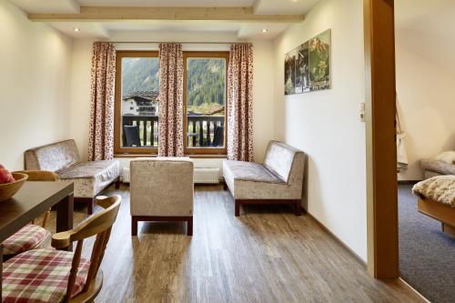 a living room with chairs and a window at Gästehaus Huber in Mayrhofen